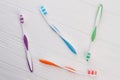 Colored tooth brushes on white wooden background. Royalty Free Stock Photo