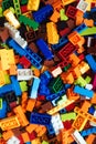 Colored toy bricks background. Pile of child`s building blocks in multiple colours, top view Royalty Free Stock Photo