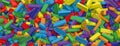 Colored toy bricks background. Rainbow colors. Random coloured plastic construction blocks. 3D illustration. 3D