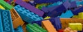 Colored toy bricks background. Rainbow colors. Random coloured plastic construction blocks. 3D illustration. 3D