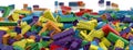 Colored toy bricks background. Rainbow colors. Random coloured plastic construction blocks. 3D illustration. 3D