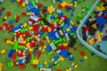 Colored toy bricks with place on green ground very messy Royalty Free Stock Photo