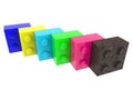 Colored toy bricks in a row with a rusty metal block in the foreground