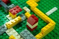 The colored toy bricks on green board. Royalty Free Stock Photo