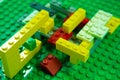 The colored toy bricks on green board. Royalty Free Stock Photo