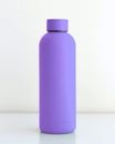 Colored tumbler bottle on white table with white background