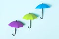 Colored umbrellas on a blue background. Conceptuality and place for the text