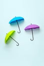 Colored umbrellas on a blue background. Conceptuality and place for the text