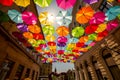 Colored umbrellas hanging between buildings Royalty Free Stock Photo