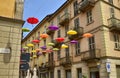 Colored umbrellas, hanging between the houses along the alleys
