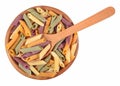 Colored uncooked italian pasta penne in a wooden bowl on a white Royalty Free Stock Photo