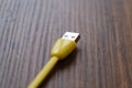 Colored USB type cable staying on dark wooden table. Royalty Free Stock Photo