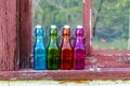 Colored Vintage Bottles on Window Sill Royalty Free Stock Photo