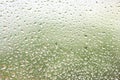 Colored water drops on window, half red and half green