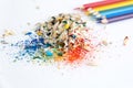 Colored watercolor pencils of rainbow colors and shavings from them after sharpening on a white background Royalty Free Stock Photo