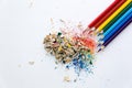 Colored watercolor pencils of rainbow colors and shavings from them after sharpening on a white background Royalty Free Stock Photo