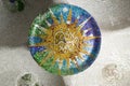 Colored wheel mosaic of colored ceramic tile by Antoni Gaudi at his Parc Guell, Barcelona, Spain Royalty Free Stock Photo