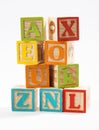 Colored Wooden Alphabet Blocks on White Background