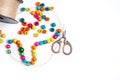 Colored wooden beads, scissors and a thread spool Royalty Free Stock Photo