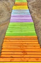 Colored wooden boardwalks on the sand.