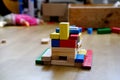 Colored wooden cubes, builds houses and rockets, the concept of the development of creativity, fine motor skills, patience and