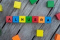 colored wooden cubes with letters. the word alnusra is displayed, abstract illustration Royalty Free Stock Photo