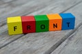 Colored wooden cubes with letters. the word front is displayed, abstract illustration Royalty Free Stock Photo