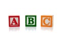 Colored wooden letter blocks on a white background