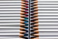 Colored wooden pencils on a black plastic backing. Top view. Royalty Free Stock Photo