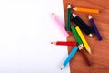 Artistic Inspiration: Colorful Wooden Pencils and Blank Paper on Wooden Desk