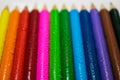 Colored wooden pencils with water drops. Art, creativity and drawing background. selective focus Royalty Free Stock Photo