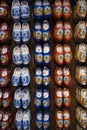Colored wooden shoes, a traditional souvenir from Holland, hanging on the wall. Royalty Free Stock Photo