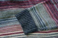 colored wool sweater with a single striped sleeve