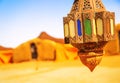 Coloreful berber lamp with traditional nomad tents on background