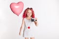 Colores hairs. Portrait of funny fashion hipster girl with pink ballon in the shape of heart. Retro camera in her hand. Royalty Free Stock Photo