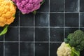 Colorfu cauliflower. Various sort of cauliflower on old stone tiles black concrete background. Purple, yellow, white and green col Royalty Free Stock Photo