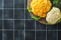 Colorfu cauliflower. Various sort of cauliflower on old stone tiles black concrete background. Purple, yellow, white and green col Royalty Free Stock Photo