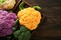 Colorfu cauliflower. Various sort of cauliflower on old wooden background. Purple, yellow, white and green color cabbages. Royalty Free Stock Photo