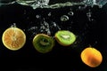 Colorfu fruits orange, lemon and kiwi splash of water on black Royalty Free Stock Photo