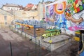 Colorful abandoned amusement park with toy cars