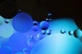 Colorful abstract background. Blue black circles and oil bubbles in the water. Close up. Macro abstraction. Rainbow oil pattern Royalty Free Stock Photo