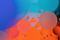 Colorful abstract background. Blue orange purple pink and red circles and oil bubbles in the water. Close up. Macro abstraction. Royalty Free Stock Photo