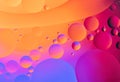 Colorful abstract background. Orange pink purple blue circles and oil bubbles in the water close-up. Macro abstraction Royalty Free Stock Photo