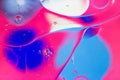 Colorful abstract background. Pink blue white circles and oil bubbles in the water closeup. Macro abstraction. Rainbow Royalty Free Stock Photo