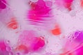 Colorful abstract background. Pink circles and oil bubbles in the water closeup. Macro abstraction. Royalty Free Stock Photo