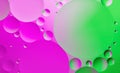 Colorful abstract background. Pink, green circles and oil bubbles in the water closeup. Macro abstraction. Royalty Free Stock Photo