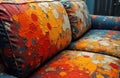 Colorful abstract patterned sofa with vibrant splashes of paint in warm tones Royalty Free Stock Photo