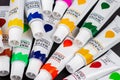 Colorful acrylic paints in tubes on dark Royalty Free Stock Photo