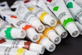 Colorful acrylic paints in tubes on dark Royalty Free Stock Photo