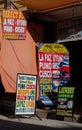 Colorful advertising banners displaying the differents services offered in a touristic shop of Copacabana, Bolivia